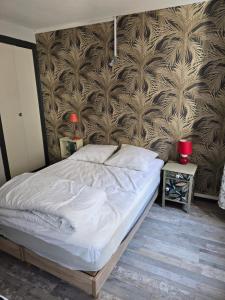 a bedroom with a large bed with a wall at duplex centre ville in Privas