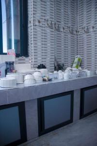 a table with white bowls and plates on it at Wete View Hotel in Wete