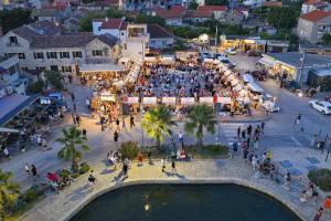 an overhead view of a crowd of people on a city street at Campanella Old Town by Mrav in Sukošan