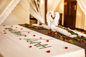 a wedding altar with white towels and red flowers at Sunrise Mount View in Ella