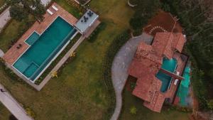 an aerial view of a house with a swimming pool at Mountain Vista Resort in Kalpetta
