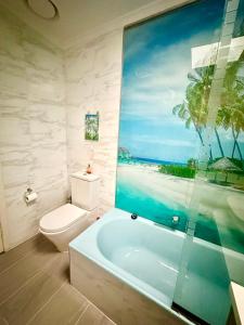a bathroom with a toilet and a bath tub at Jalynn homestay in Glen Waverley