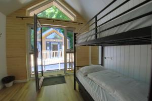 a bedroom with a bunk bed and a large window at Château du Baffy in Colombiers-sur-Seulles