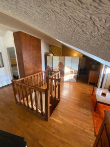 a living room with a wooden floor and a staircase at Villa i 2 Pini in Pila +33 photos
