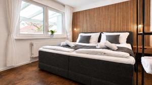 a large bed in a room with a window at Wohnung für 4 Personen, 2 Schlafzimmer, Küche, Wlan in Großostheim