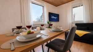 a dining room table with a bowl of food and wine glasses at Wohnung für 4 Personen, 2 Schlafzimmer, Küche, Wlan in Großostheim +10 photos