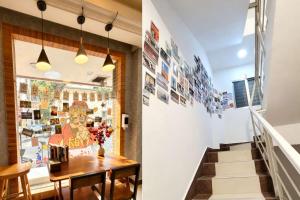 a room with a staircase and a table with flowers at YangShuo Backpacker Hostel West Street Branch in Yangshuo