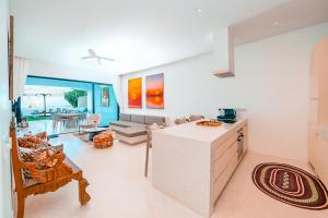 a kitchen and living room with a couch and a table at One Ocean Hotel Apartments by Nest & Nomad in Msambweni