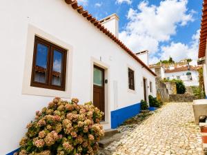 a white house with a plant in front of it at Casa Nº9 - Vila d'Óbidos in Óbidos