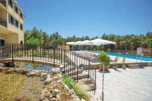 a resort with a pool and a bridge over a pond at Mobile Homes Vrata Krke in Lozovac