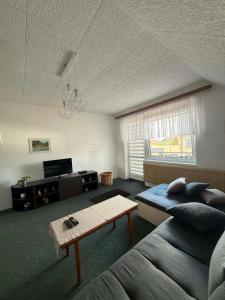 a living room with a couch and a table at Pension Barborka in Jičín