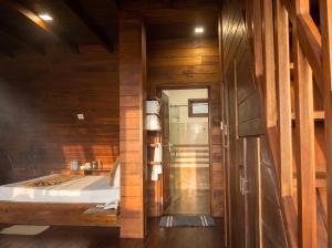 a bathroom with a bed and a shower in a room at Top Mountain Resort in Diyatalawa +179 photos