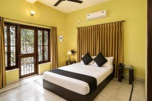 a bedroom with a large bed and a window at Next Generation Guest House in kolkata +15 photos