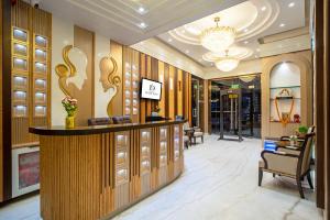 a hotel lobby with a reception counter and a chandelier at The Delhi Star Hotel near Connaught Place- New Delhi in New Delhi