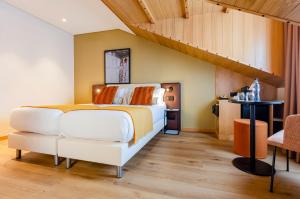 a bedroom with a large bed and a staircase at Ouro Rossio Hotel in Lisbon