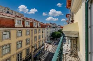 a view of a street from a balcony of buildings at Ouro Rossio Hotel in Lisbon