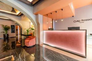 a lobby with a red bench in a building at Ouro Rossio Hotel in Lisbon