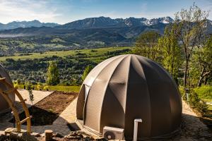 a dome tent with mountains in the background at ZakoGlamp Glamping Pod Gubałówką z Jacuzzi in Ząb