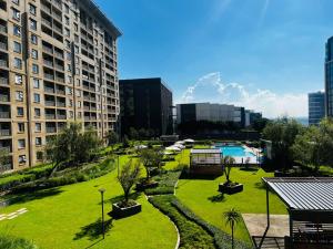a view of a park with a pool and buildings at Prestige Apartments Sandton at Westpoint in Johannesburg