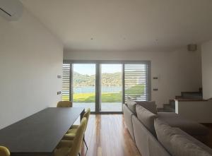 a living room with a table and chairs and a large window at Prestigiosa vista lago in Como