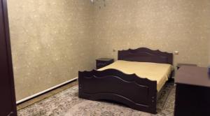 a bedroom with a bed and two night stands at Bars guest House in Barskoon