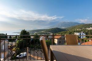 a balcony with a view of a city and mountains at ZIS LUX Apartments Pool in Utjeha