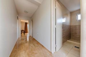 a hallway with a walk in shower and a walk in shower at ZIS LUX Apartments Pool in Utjeha +64 photos