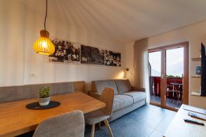 a living room with a couch and a table at Krebishof Agriturismo in Schenna