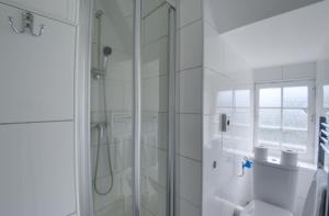 a white bathroom with a shower and a toilet at Château du Baffy in Colombiers-sur-Seulles +113 photos