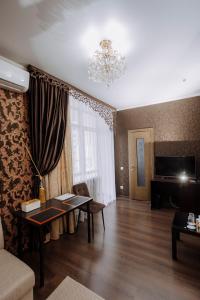 a living room with a couch and a table at Hotel Gloria in Kostanay