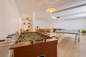 a room with a foosball table and a pool table at Beach Villa with ocean view in Lourinhã