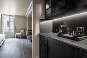 a kitchen with a counter with a coffee maker at Hôtel Villa d'Estrées - Saint-Germain in Paris