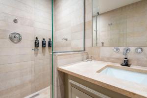 a bathroom with a sink and a shower at Hôtel Villa d'Estrées - Saint-Germain in Paris +14 photos