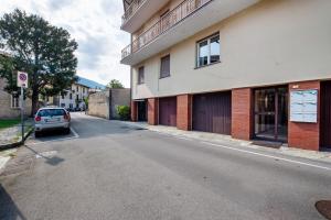 a car parked on a street next to a building at Maddy's House in Mandello del Lario