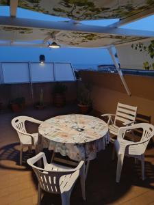 a table and chairs in a room with a table at Terrazza con vista in Nettuno