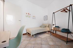 a room with a bed and a chair in it at Maddy's House in Mandello del Lario