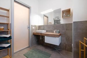 a bathroom with a sink and a mirror at Maddy's House in Mandello del Lario +19 photos