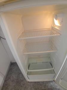 an empty refrigerator with its door open at COSTACABANA Apartamento in Almería