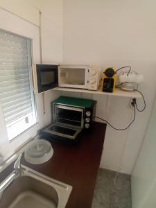 a microwave oven sitting on a counter in a kitchen at COSTACABANA Apartamento in Almería