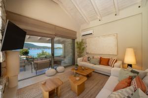 a living room with a couch and a tv at Villa Carina by TwentyTwo in Ancient Epidauros