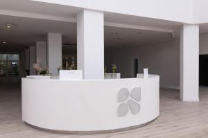 a white counter with two silver scissors on it at BLUESEA Costa Jardin & Spa in Puerto de la Cruz