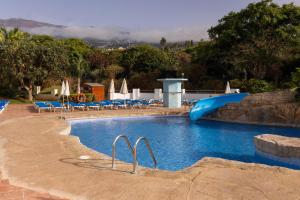 a swimming pool with a slide in a resort at BLUESEA Costa Jardin & Spa in Puerto de la Cruz +38 photos