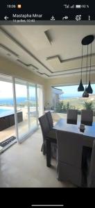 a room with a table and chairs with a view of the ocean at Exclusive luxury villa private pool and garden mnar in Tangier +10 photos