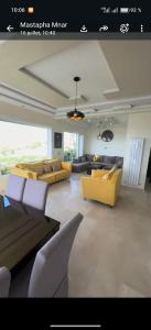 a living room with couches and chairs in a room at Exclusive luxury villa private pool and garden mnar in Tangier