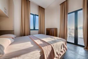 a bedroom with a large bed and a large window at ZIS LUX Sea View in Kravlja
