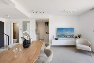 a living room with a wooden table and chairs at  