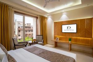 a hotel room with a bed and a window at The Delhi Star Hotel near Connaught Place- New Delhi in New Delhi +40 photos
