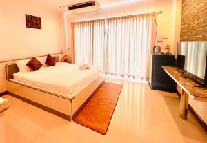 a bedroom with a bed and a large window at Ree- Riverside hotel in Bangkok +76 photos