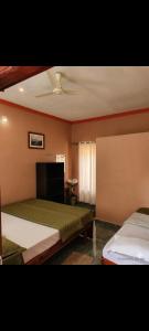 a bedroom with two beds and a ceiling at Belandoor Nature Nest in Sringeri +11 photos