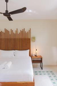 a bedroom with a bed and a ceiling fan at TreeHouse Boutique Hotel, an adults only boutique hotel in Mérida